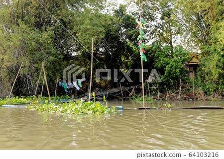 Traditional Thai house by the water Traditional Thai house by the water 64103216
