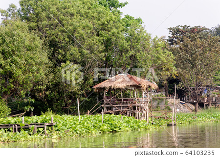 Traditional Thai house by the water Traditional Thai house by the water 64103235