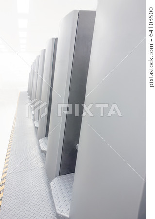 A multicolor sheet-fed printing press viewed from an oblique side. 64103500