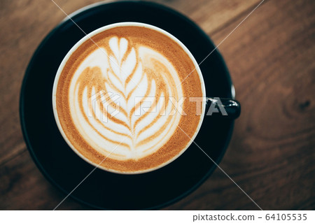 Red cup of cappucino with beautiful latte art Red cup of cappucino with beautiful latte art 64105535