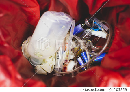 Medical infectious waste in red garbage. Medical infectious waste in red garbage. 64105859
