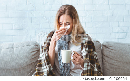 Girl with cup, wipes nose during covid-19 epidemic Girl with cup, wipes nose during covid-19 epidemic 64106934