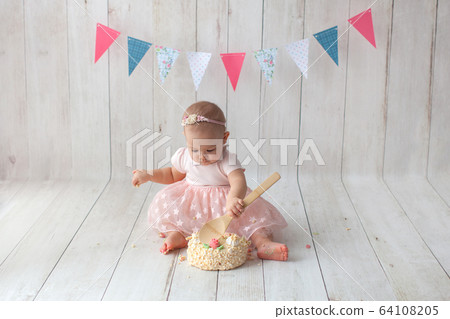 First baby birthday. Flag garland on background. Smash cake.  64108205