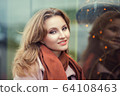 young business woman in warm clothing enjoying 64108463