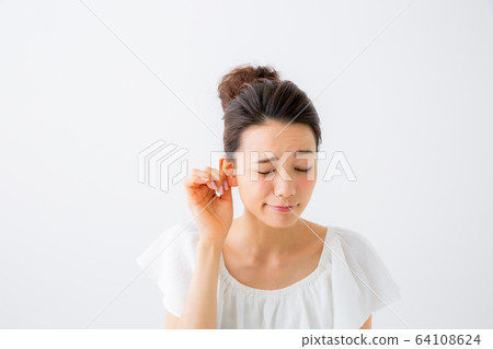 Woman pinching ears Woman pinching ears 64108624