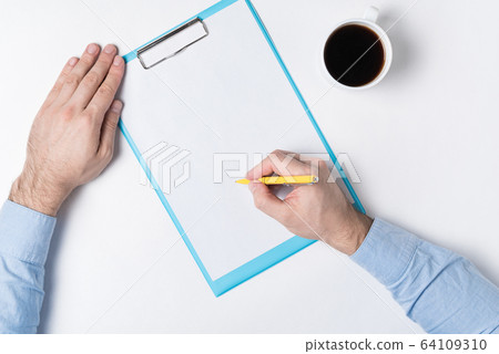 Man writes on white sheet. Top view of man hands, Man writes on white sheet. Top view of man hands, 64109310