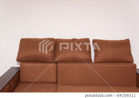 Brown corner sofa with large cushions. Upholstered Brown corner sofa with large cushions. Upholstered 64109311
