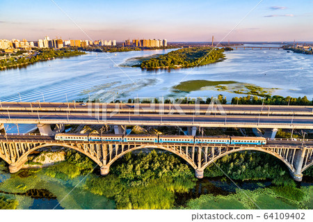 Kiev Urban Train on the Darnytsia Bridge across the Dnieper in Ukraine 64109402