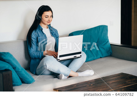 Young woman working from home online using laptop 64109782