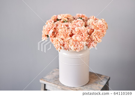 Bouquet of carnation flowers peach color. Spring background. Clove bunch present for Mothers Day. 64110169