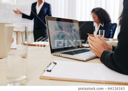 Woman attending business meeting 64116163