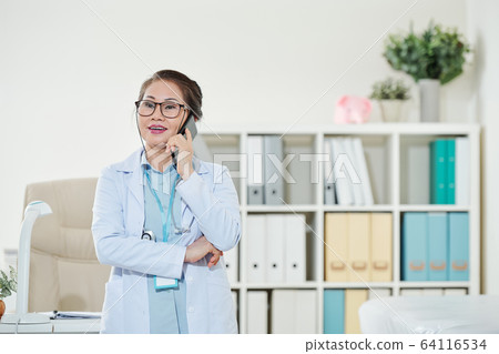General practitioner talking on phone General practitioner talking on phone 64116534