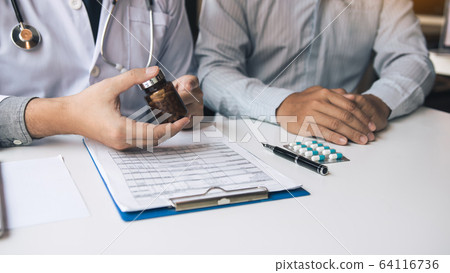Confident doctor man holding a pill bottle and Confident doctor man holding a pill bottle and 64116736