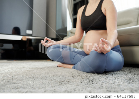 Meditating pregnant woman 64117695