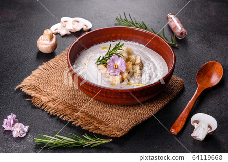 Delicious beautiful mushroom soup in a brown plate 64119668
