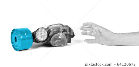 Arm reaching for vintage gasmask isolated on white Arm reaching for vintage gasmask isolated on white 64120672