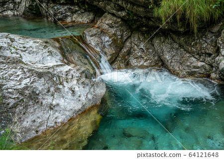 waterfall with clear green water 64121648