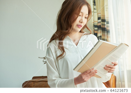 年輕女子快樂輕鬆陽光明媚的早晨讀書 64121673