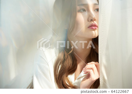 Young woman window sunshine beauty skin whitening 64122667