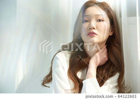 Young woman window sunshine beauty skin whitening Young woman window sunshine beauty skin whitening 64122681