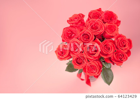 Bouquet of red roses on pink background 64123429
