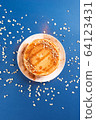 Oat pancakes on a white dish with nuts and syrup, 64123431