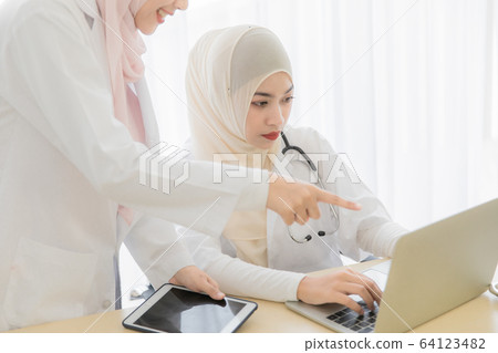 Woman doctor and muslim patient 64123482