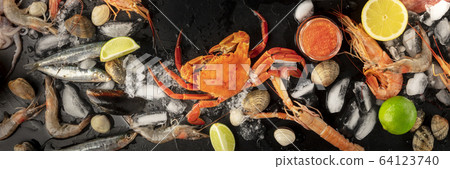 Seafood. Crab, mussels, shrimps, clams on ice, shot from the top on a black background Seafood. Crab, mussels, shrimps, clams on ice, shot from the top on a black background 64123740