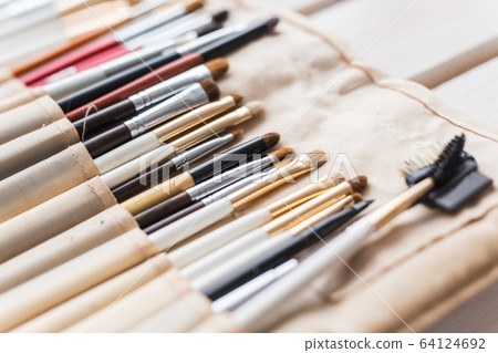 Makeup, beauty and cosmetics concept - Set of make-up brushes in a light case. Makeup, beauty and cosmetics concept - Set of make-up brushes in a light case. 64124692