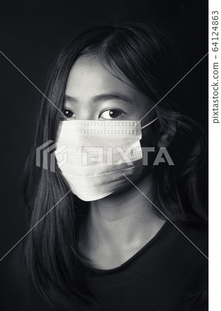 Asian young girl wearing medical face mask, studio portrait Asian young girl wearing medical face mask, studio portrait 64124863