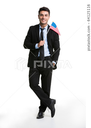 Caucasian businessman lifting America flag . 64125116