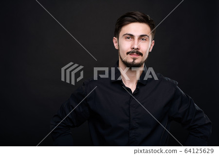 Handsome young man in black Handsome young man in black 64125629