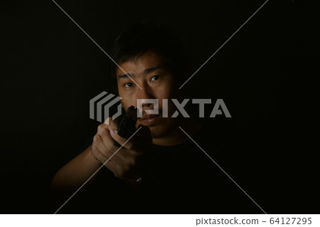 Asian murderer man aiming gun to victim, Suspect preparing to shoot. Asian murderer man aiming gun to victim, Suspect preparing to shoot. 64127295