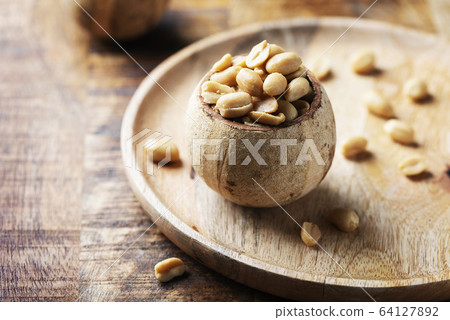 Salt peanut on the wooden table 64127892