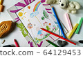 Children's color picture or drawing in a frame with colourful pencils, crayons and toys 64129453
