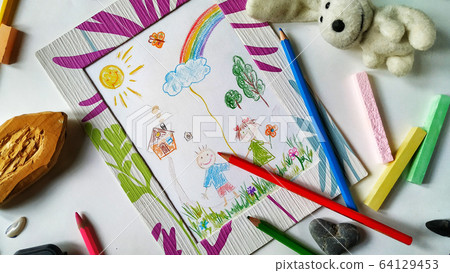 Children's color picture or drawing in a frame with colourful pencils, crayons and toys Children's color picture or drawing in a frame with colourful pencils, crayons and toys 64129453