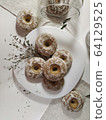 Iced homemade gingerbreads on a white plate in light pastel tones 64129525
