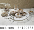 Iced homemade gingerbreads on a white plate in light pastel tones 64129573