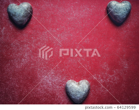 Red dusty background with heart shaped sweet biscuits and text space for valentine's day Red dusty background with heart shaped sweet biscuits and text space for valentine's day 64129599