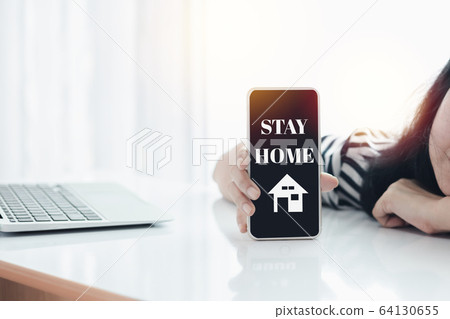 Woman's hand holding smartphone with outbreak alert notification 64130655