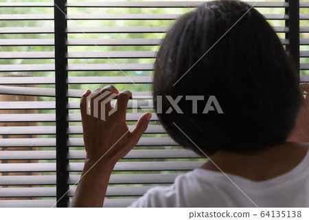 Watch the nature through the blinds. Peep through 64135138