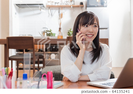 Young woman working remotely 64135241