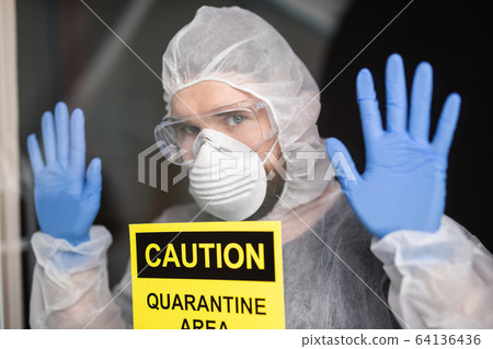 Man in protective white overalls, mask and glasses on his face. Coronavirus, pandemic, covid-19, flu and quarantine concept. Man in protective white overalls, mask and glasses on his face. Coronavirus, pandemic, covid-19, flu and quarantine concept. 64136436