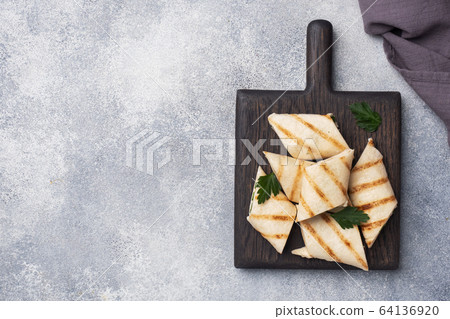 Roll with cheese and herbs. Grilled pita bread 64136920