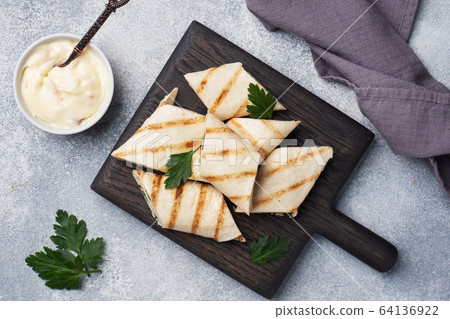 Roll with cheese and herbs. Grilled pita bread 64136922