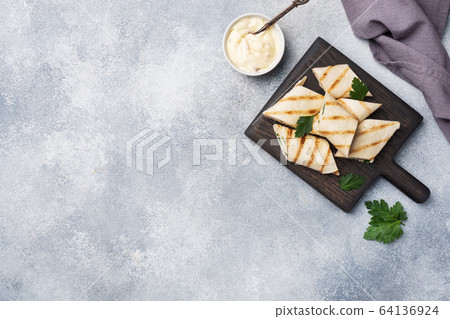 Roll with cheese and herbs. Grilled pita bread Roll with cheese and herbs. Grilled pita bread 64136924