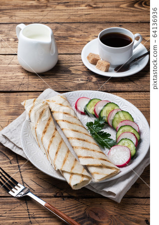 Roll with cheese and herbs. Grilled pita bread 64136936