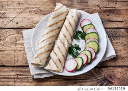 Roll with cheese and herbs. Grilled pita bread 64136939