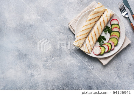 Roll with cheese and herbs. Grilled pita bread Roll with cheese and herbs. Grilled pita bread 64136941