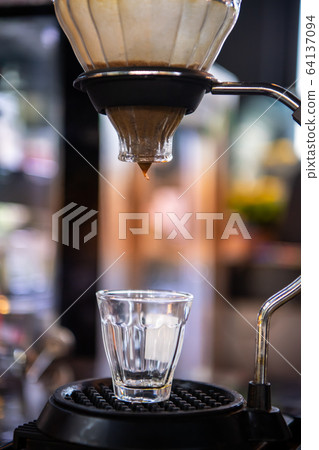Close up of coffee brewing gadgets, Drip Coffee, in low-light. Close up of coffee brewing gadgets, Drip Coffee, in low-light. 64137094